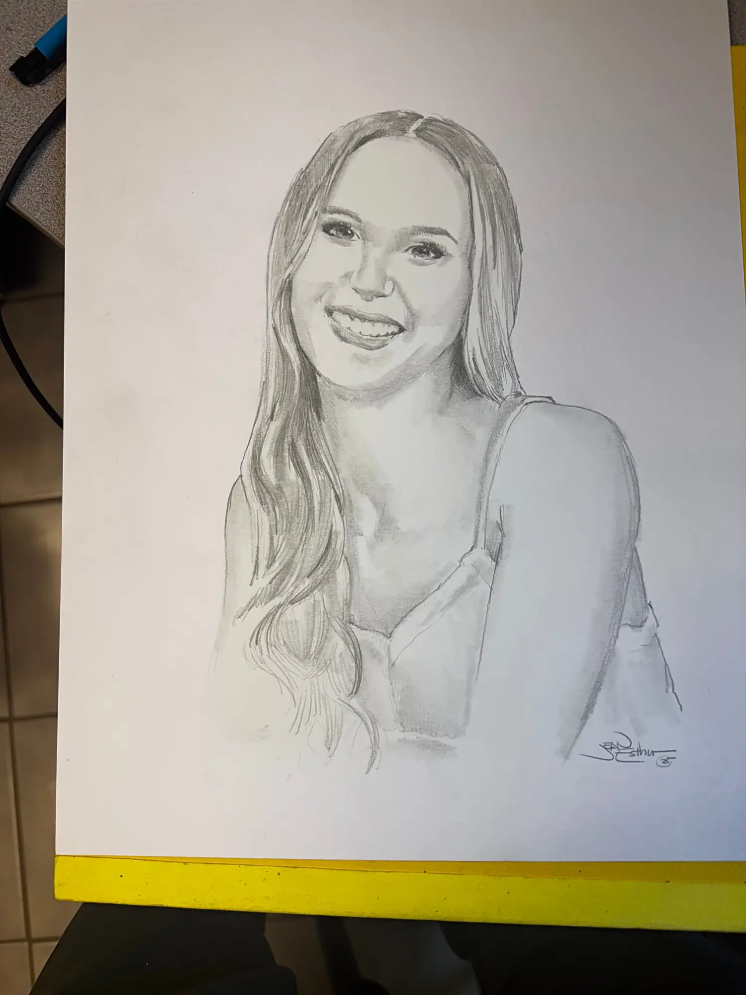 Pencil portrait of a smiling young woman with long hair