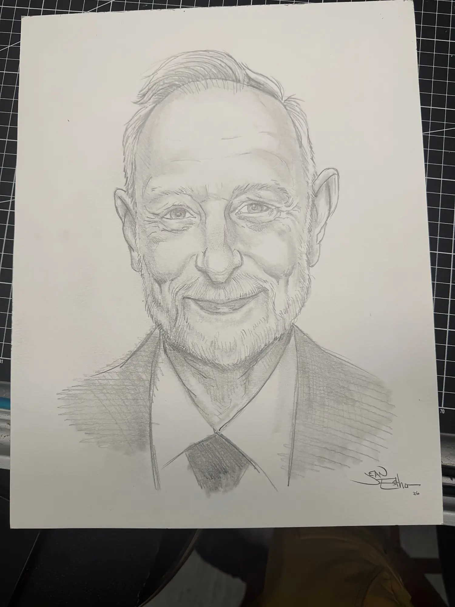Pencil portrait of a smiling man in a suit and tie