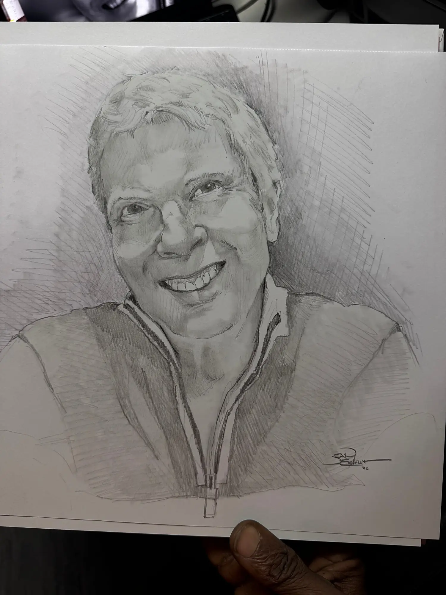 Pencil portrait of a smiling woman in a zip-up jacket
