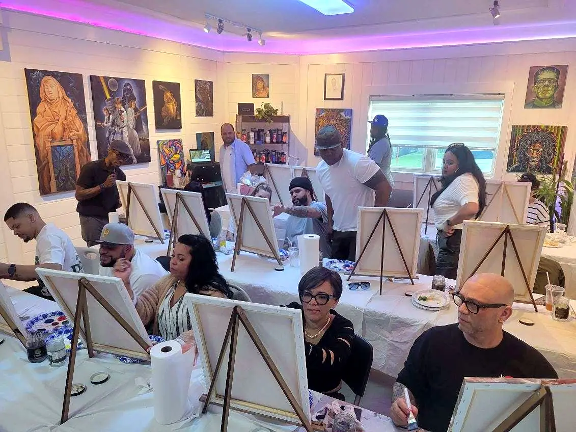 Guests painting at their easels during a studio paint party