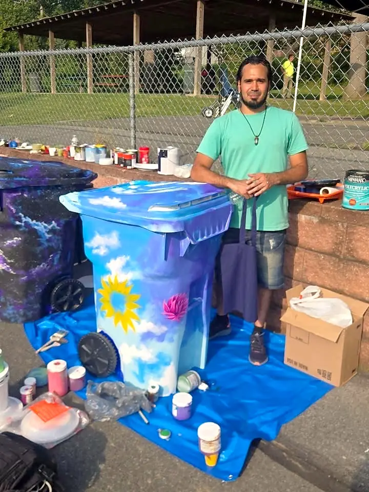 Painting a recycling bin at a community art day