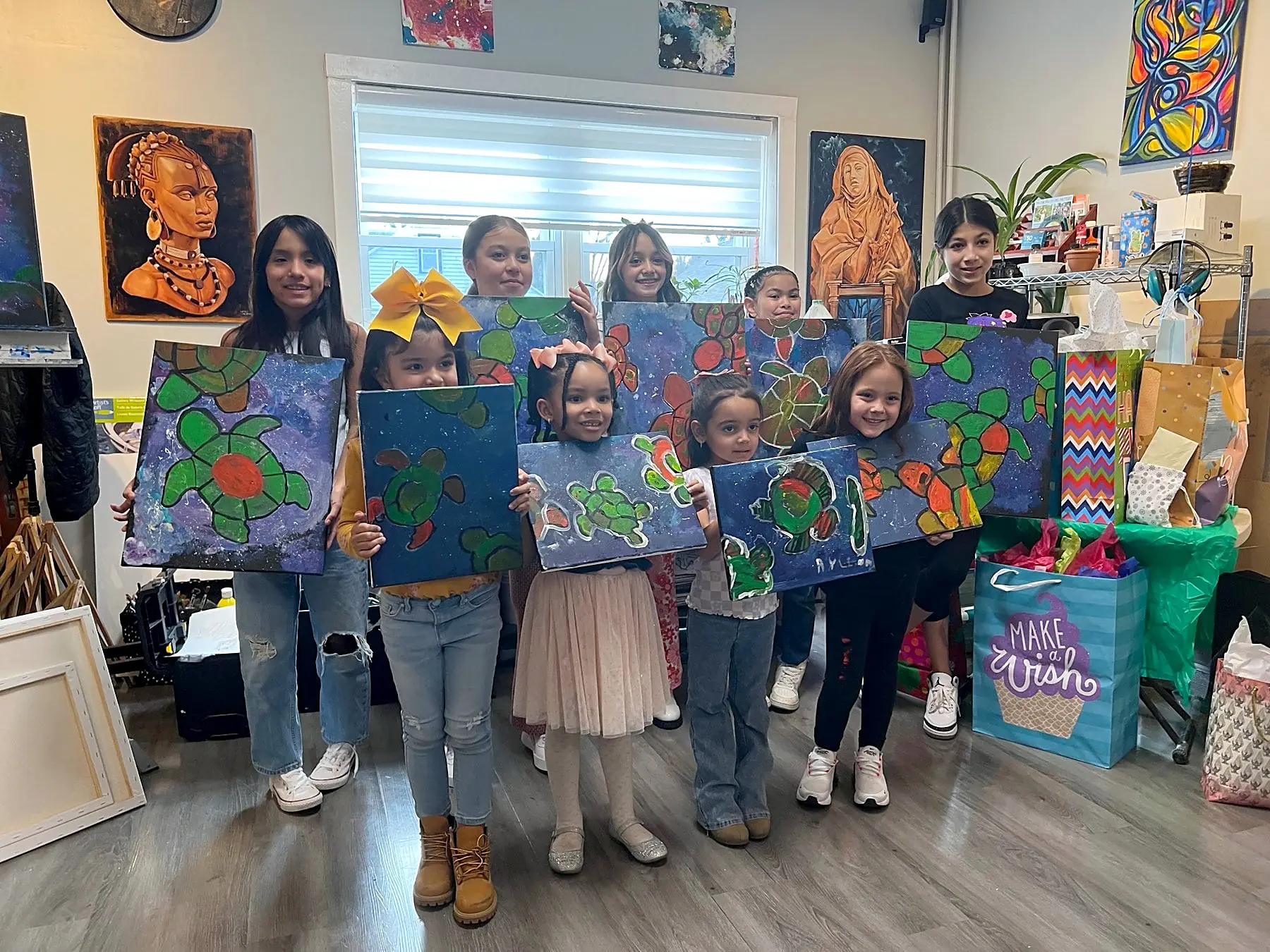 Young painters showing their turtle paintings