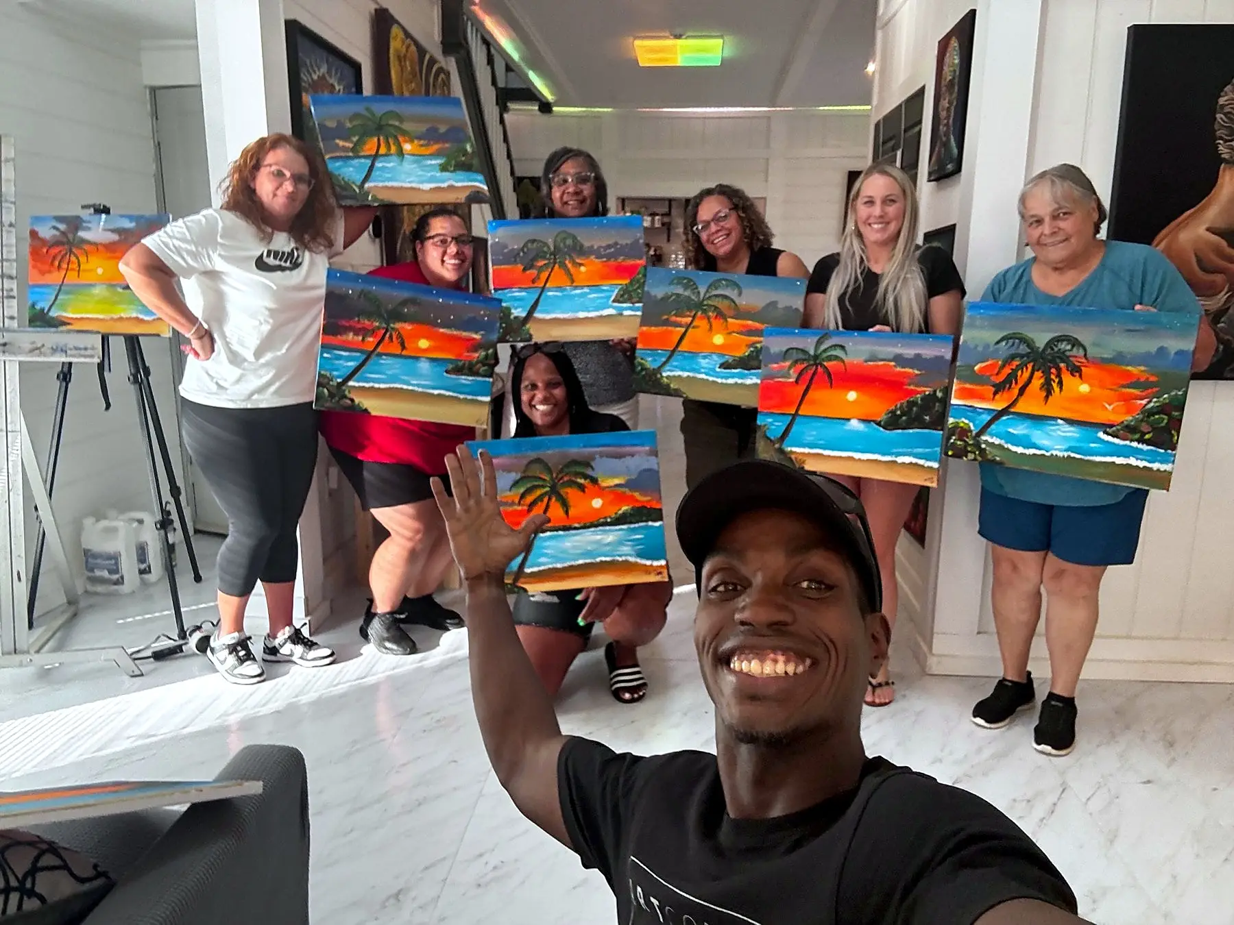 Paint party group showing their beach paintings with Jean Esther
