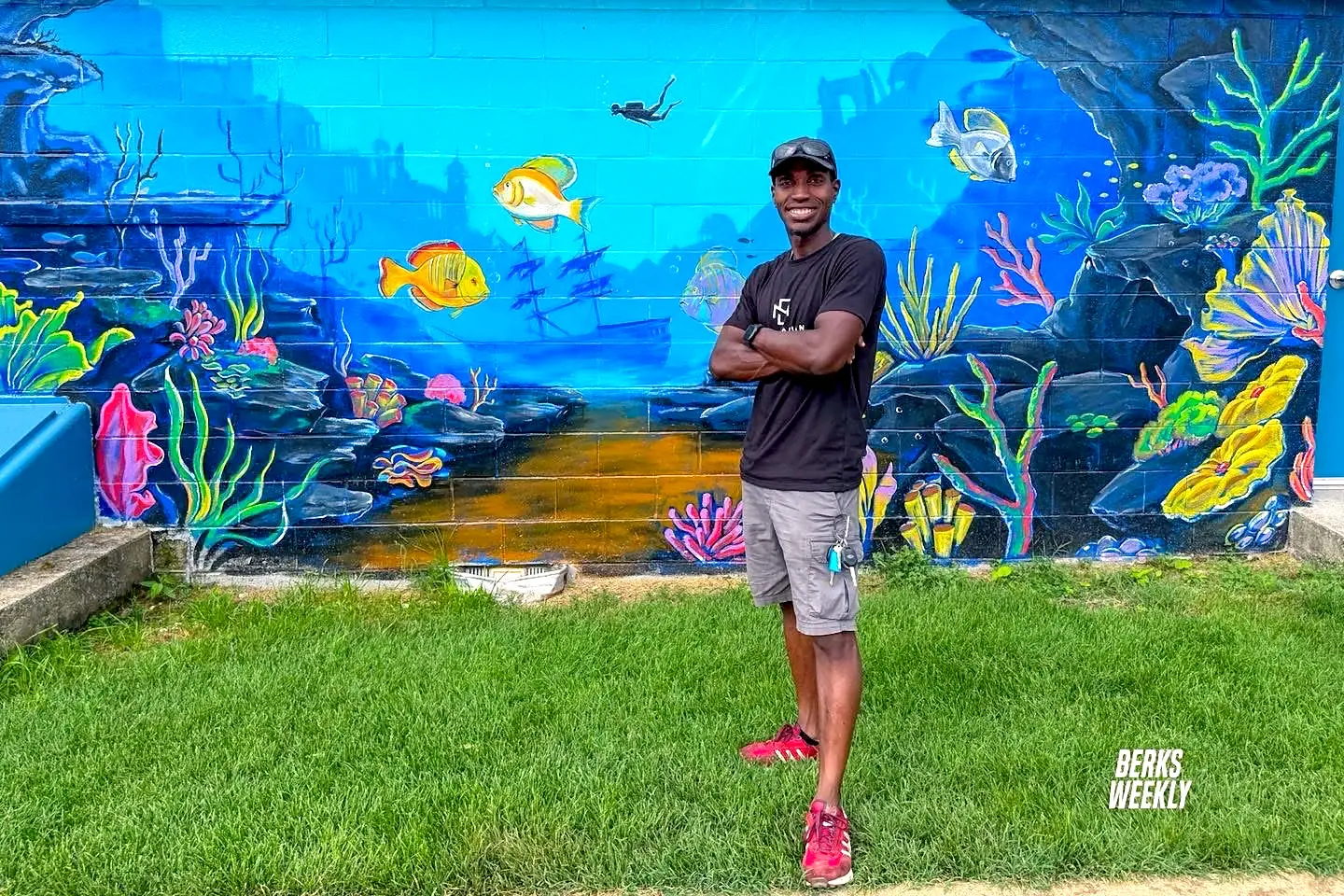Jean Esther in front of an underwater mural
